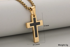 Macro detail of gold and black stainless steel cross pendant with 31mm size measurement