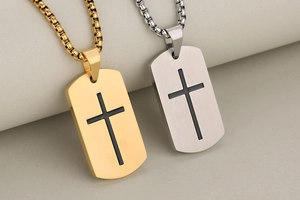 Detailed macro of gold and silver dog tag pendants with black crosses and box chains