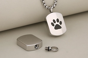 Macro shot showing the screw-open bottom of the stainless steel pet cremation pendant