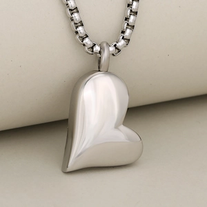 Polished stainless steel heart cremation pendant with box chain on elegant display