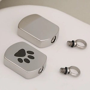 Polished stainless steel pet urn necklace with black paw print and screw seal rings