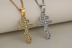 Macro shot of gold and silver Slavic Orthodox cross pendants with engraved details