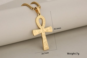 Detailed view of golden Ankh cross pendant with ancient Egyptian hieroglyphics