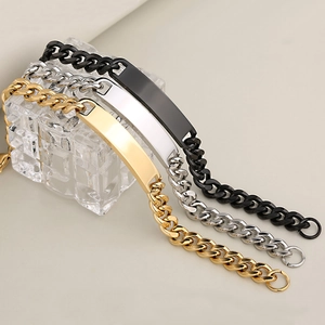 Sleek stainless steel bar bracelets in gold, silver, and black on glass blocks