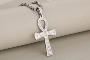 Detailed macro view of silver Ankh cross pendant with intricate Egyptian hieroglyphic symbols