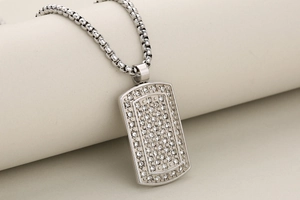 Close-up of hip-hop silver military dog tag pendant with micro-pave crystals on a box chain