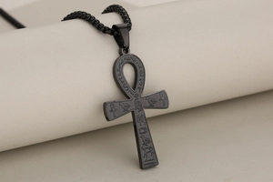Macro shot of matte black stainless steel Ankh cross pendant with ancient hieroglyphics