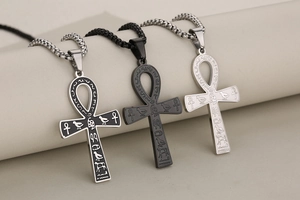 Detailed view of Egyptian Ankh pendants in silver and black finishes with hieroglyphs