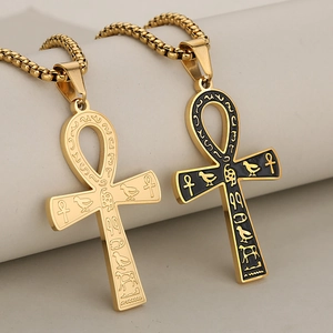 Gold and black enamel Egyptian Ankh cross pendant necklaces on minimalist display