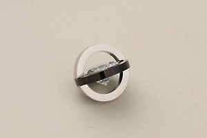 Macro detail of geometric starry sky pendant with interlocking silver and black rings