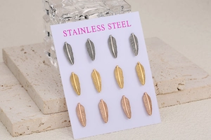 Detail showing 12-piece stainless steel feather stud earrings in silver, gold, and rose gold