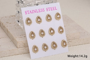 Detail of six pairs of gold-plated stainless steel teardrop stud earrings with pavé crystals
