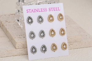 Set of 12 teardrop crystal stud earrings in gold and silver finish on display card