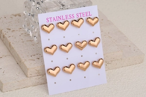 Macro shot of twelve minimalist heart-shaped stainless steel earrings in rose gold finish