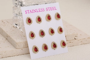 Detail view of red teardrop-shaped zircon earrings with gold stainless steel setting