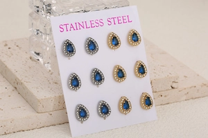 Detail of six pairs of stainless steel water drop earrings with blue and white zircons