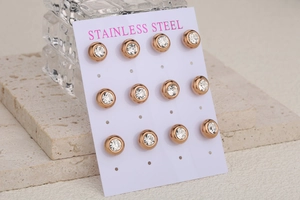 Detailed set of six rose gold stainless steel round stud earrings with sparkling crystals