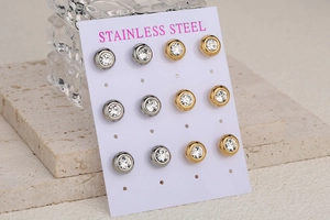 Detail view of six pairs of round cubic zirconia stainless steel stud earrings set on a card