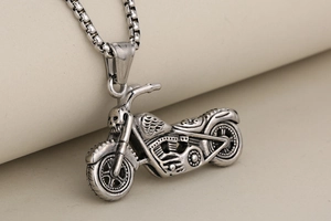 Détail du pendentif moto punk vintage avec tête de mort et chaîne box argentée