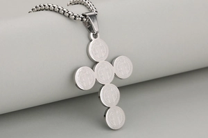 Detailed close-up of Saint Benedict cross pendant in matte stainless steel with carvings