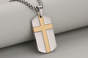 Makroaufnahme von zweifarbigem Edelstahl Dog Tag Anhänger mit goldenem Kreuz und Kette