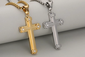 Detail view of double-layered stainless steel cross necklaces in gold and silver finish