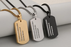 Detailed macro view of brushed stainless steel dog tags with inlaid micro zircons