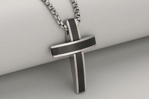 Detailed close-up of a 3D stainless steel cross pendant with black matte inlay