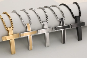 Detail view of five multi-color stainless steel cross pendants with matte and polished finishes