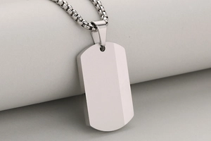Macro shot of brushed stainless steel military tag pendant with silver bead chain