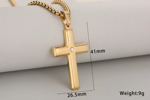 Detailed view of gold cross pendant with cubic zirconia and dimensions 41mm by 26.5mm