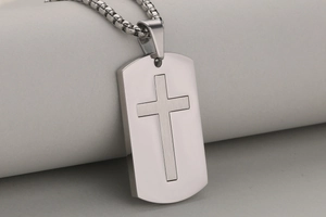Detailed close-up of a stainless steel cross dog tag pendant with a box chain