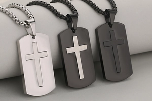 Detailed view of stainless steel cross military pendants in silver and black finishes