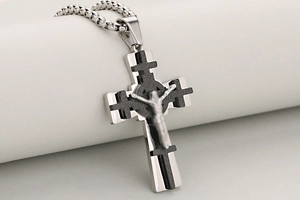 Makroaufnahme von 3-lagigem poliertem Edelstahl-Kruzifix-Anhänger mit detaillierter Jesus-Figur