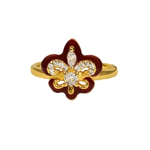 Vintage gold fleur-de-lis open ring with red enamel and pavé crystals on white background