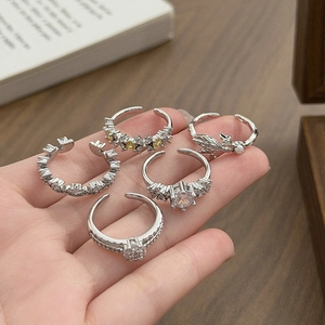 Silver adjustable ring set with sparkling zircons and pearls on a hand display