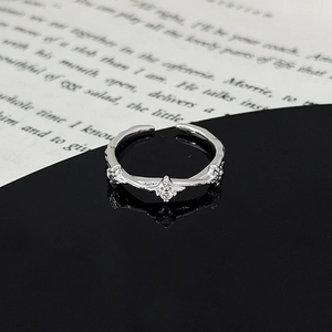 Close-up of adjustable star leaf ring with zircon and vintage engraving on black mirror