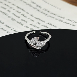 Macro shot of silver leaf ring with micro-set zircons and textured adjustable band