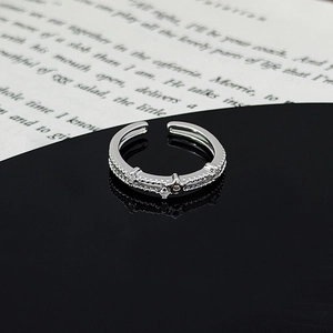 Macro shot of silver-toned double band ring with star charm and zirconia inlay details