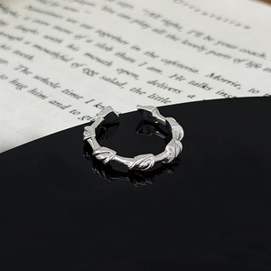 Detailed view of silver open ring with unique bamboo thorn texture and shiny metallic finish