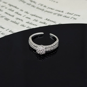 Macro detail of silver ring with zircon flower pattern and double row pavé setting