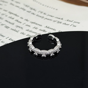 Macro shot of silver wave ring with pavé zircons showing fine crown details and polish