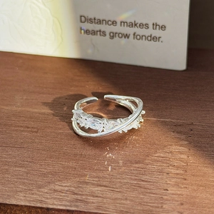 Close-up of silver open ring with pavé marquise and round cubic zirconia in a double band