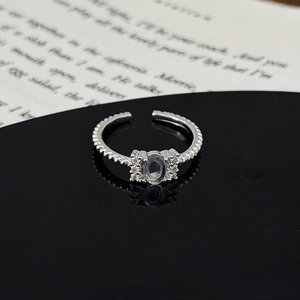 Macro shot of silver adjustable ring with oval gemstone and twisted rope texture design