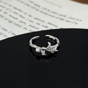 Close-up of silver leaf ring featuring a white pearl and sparkling zircon details