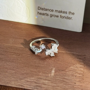 Macro view of adjustable silver ring featuring zircon butterfly and star moon elements