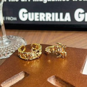 Detalle de anillos dorados vintage con motivos celestiales de estrella, luna y pegaso