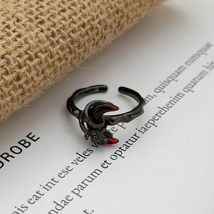 Detailed close-up of Gothic gunmetal open ring with red crescent accents and textured band
