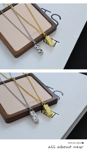 Detail of gold and silver rectangular pendant necklaces with crushed ice texture