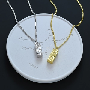 Minimalist geometric pillar pendant necklaces in gold and silver finish with textured surface